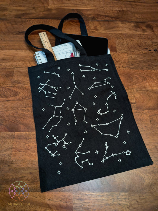 Black bag with white constellation graphic on a wooden table.